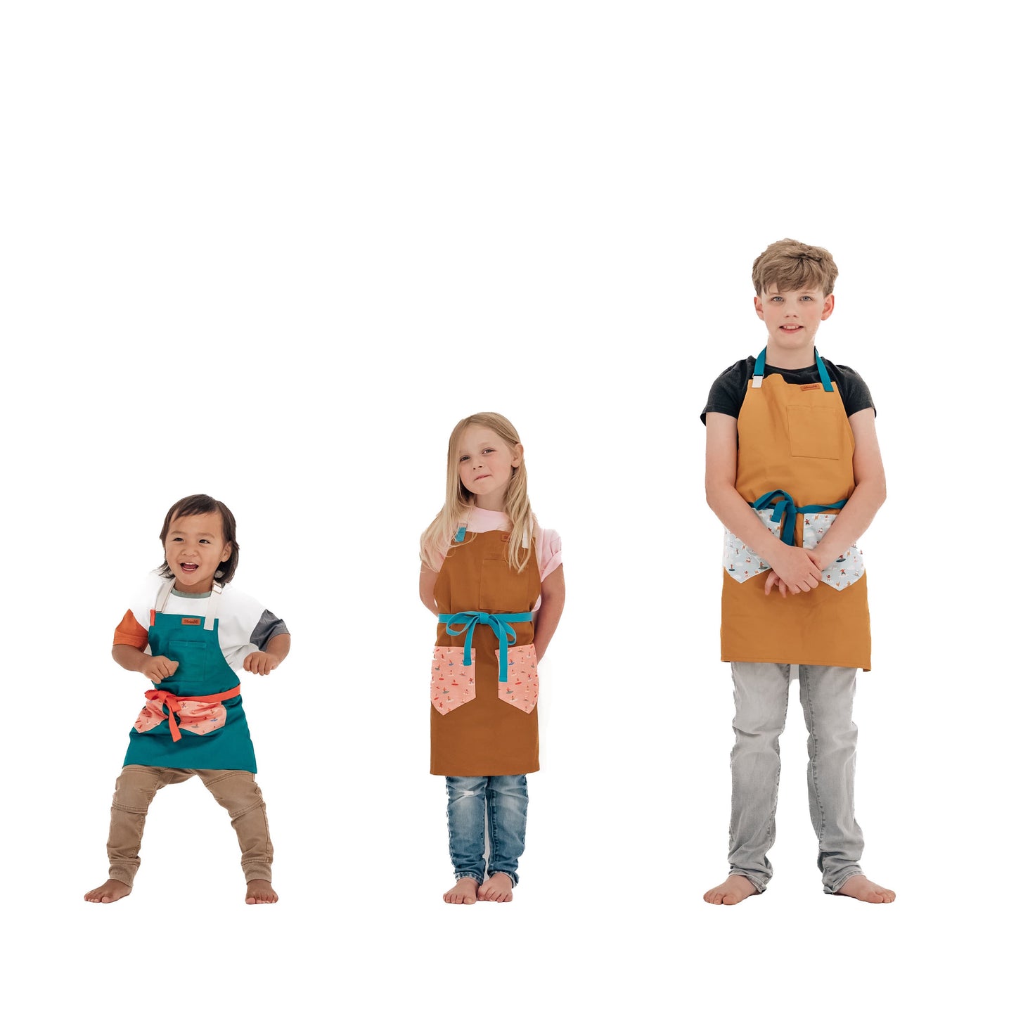 Kids surf apron Durable child apron Soft fabric apron Leather accent apron Bronze details apron Surf-themed apron Child kitchen apron Beach style apron Eco-friendly kids apron Stylish children's apron Durable apron for kids Kids cooking apron Leather strap apron Ocean design apron