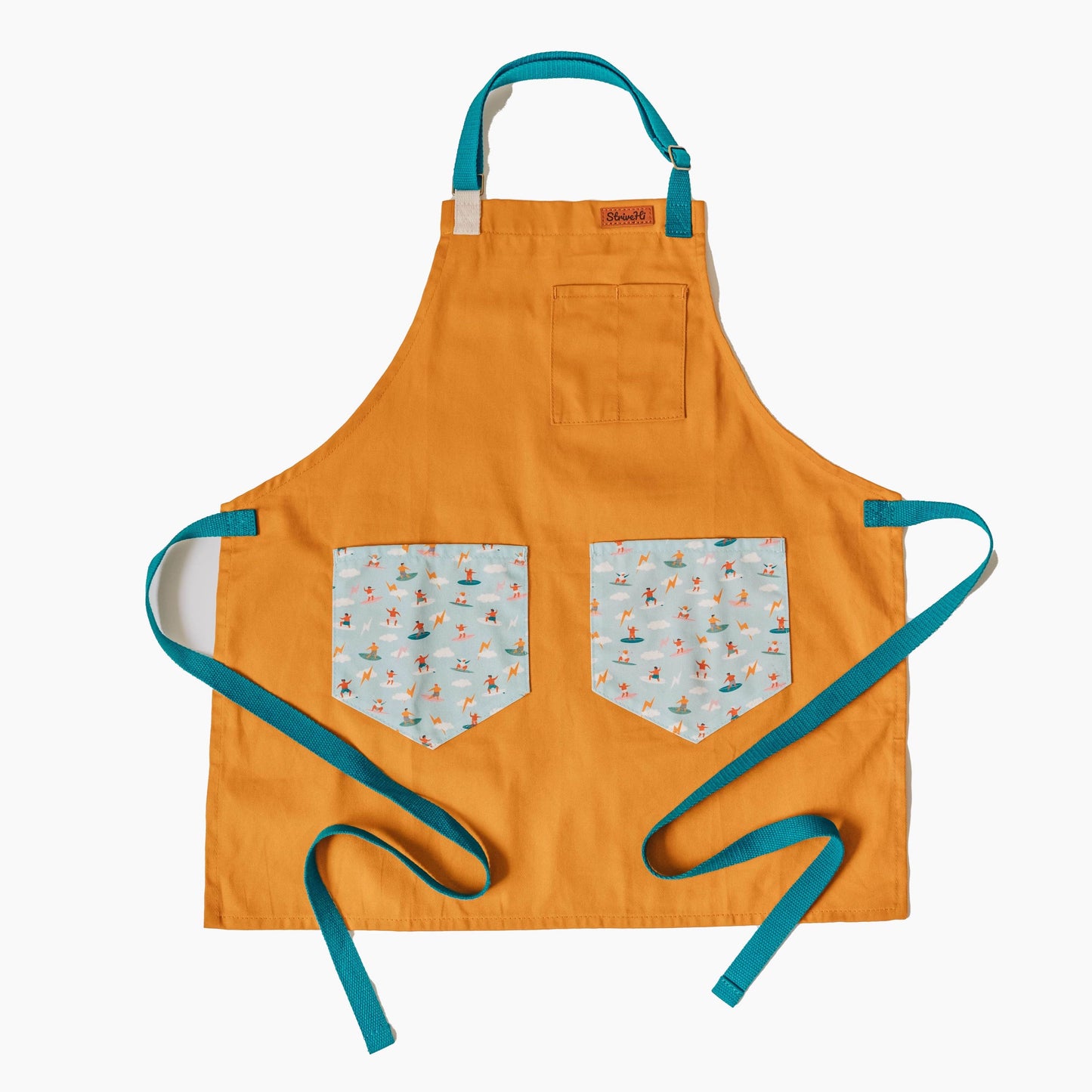 Kids surf apron Durable child apron Soft fabric apron Leather accent apron Bronze details apron Surf-themed apron Child kitchen apron Beach style apron Eco-friendly kids apron Stylish children's apron Durable apron for kids Kids cooking apron Leather strap apron Ocean design apron